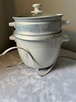 Rice cooker assembled with lid and steamer insert visible