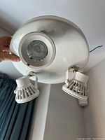 Underside view of entire ceiling light showing three adjustable spot heads and central fixed light