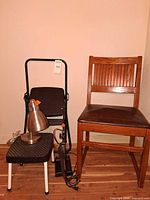 Overall lot view showing chair, two step stools and brushed metal lamp