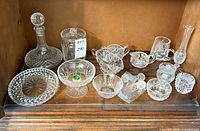 All crystal pieces and spoons arranged on shelf