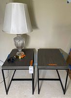 Two gray side tables and lamp on left table