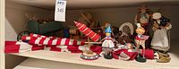 Shelf view with Lori Mitchell figurines, flags, wheelbarrow décor