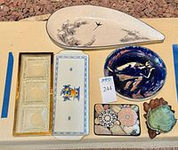 Group shot of all nine serveware items on surface