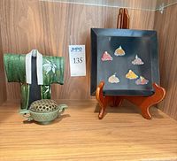 Group shot of tray on stand, kimono sculpture, and censer