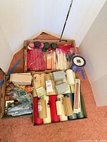 Two cartons containing assorted candles, essential oil set, napkin rings and metal pieces