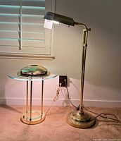 Both lamps plugged in and illuminated beside window