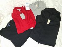 Four cashmere sweaters: red with tag, grey collared, black crewneck, black hooded