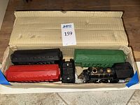 Train pieces in box: locomotive, tender, three passenger cars