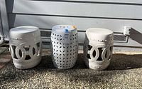 Front view of three ceramic garden stools side by side