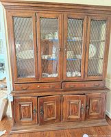 Full front view of china cabinet showing glass doors and storage base