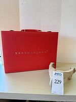 Closed red XRBRMAHJONG case and bone cribbage board