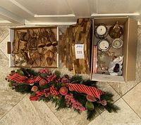 Boxes containing wooden nativity figures, wooden stable pieces and garland
