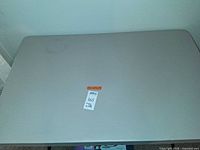 Top view of rectangular light gray folding table showing minor stains