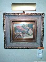 Front view of framed painting with picture light