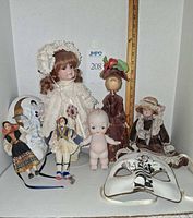 Group shot of all dolls and masks for size reference