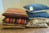 Stacked pillows showing eight total with various patterns and colours