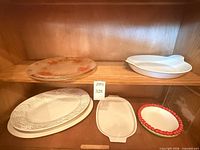 Five ceramic pieces on shelves