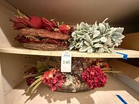 Shelf view showing red wreath, lamb’s-ear foliage bundle and basket floral arrangement