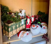 Shelf with greenery wreaths, garland and foam heads