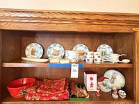 Shelf with Portuguese plates, Evesham crocks, onion soup bowls, Hummel plate, cookie cutter box