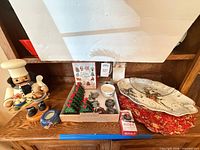 Full lot showing platter, nutcracker, placemats, candle, cookie cutters, place-card holders, napkin rings