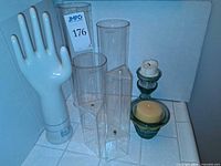 group shot of glove mold, oil lamps, vases, green candle holders with candles