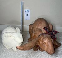 Front view of both ceramic rabbits with ruler for scale