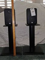 pair of JBL speakers on stands front view