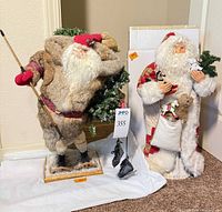 Both Santa figurines side by side on floor