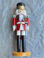 Front view of red soldier nutcracker on base