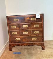 Front view showing nine drawers with brass recessed pulls