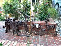 All three rustic metal deer and wire pumpkin displayed together on brick patio