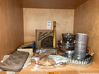 Overall lot showing bundt pans, tart pans, mini cups, silicone mold, cookie press and cake divider