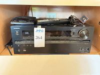 Front view of Onkyo receiver with remote, Panasonic CD player and accessories on top