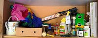 Shelf with watering can, flags, kneeler, fertilizers, spool, box