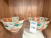 Pair of Kutani bowls on shelf showing exterior designs