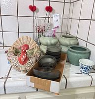 Group view of planters, vases, smoked-glass dishes, turkey centerpiece