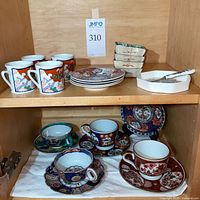 Overall lot with cups, saucers, plates, dishes on two shelves