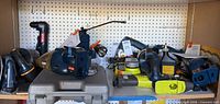 Shelf of assorted Ryobi cordless power tools