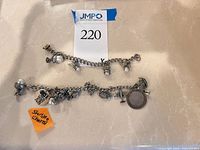 Both silver charm bracelets displayed to show overall design