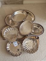 Pile of assorted silver-plated bowls and trays
