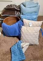 Group shot of basket, throw, accent pillows and pillowcases