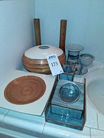 All vanity accessories and bobbin candle holders on countertop