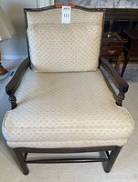 Front view of mahogany arm chair showing upholstery and frame