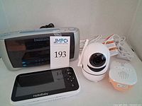 Group view showing HelloBaby screen, HelloBaby camera, VTech audio monitor, Emerson clock radio