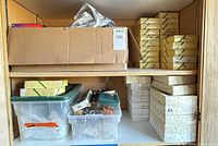 Shelved cardboard box and multiple ornament boxes