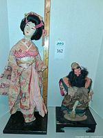 Front view of both dolls with ruler for scale