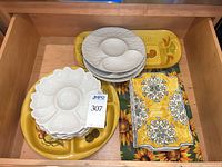 Drawer view showing all six ceramic serving pieces