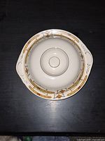 Bowl with lid in place, showing top view of pattern and handles