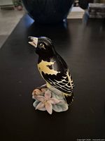 Front view of Crown Ceramic oriole figurine showing color and details